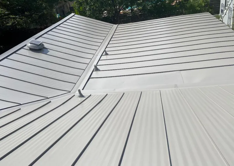 Solar attic fan installed on a metal roof for Roof Ventilation in Waipio Acres